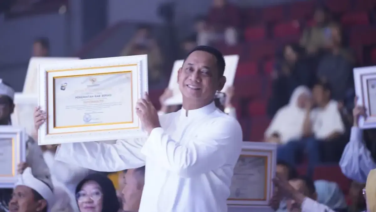 Plt Bupati Bekasi Asep Surya Atmaja memamerkan penghargaan informatif