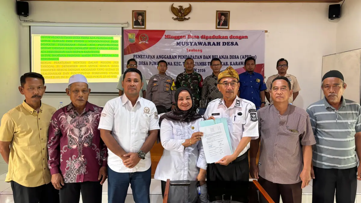 Kepala Desa Purwardana E. Heryana menyerahkan berkas APBDes kepada Kasipem Kecamatan Telukjambe Timur Nenti