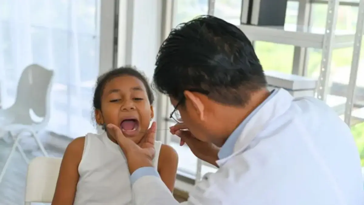 Dokter sedang meriksa gigi anak kecil