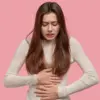 Ilustrasi seorang perempuan sedang menjaga kesehatan mental saat mengalami PMS.